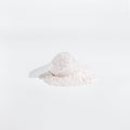 White scoop with powder on a white background